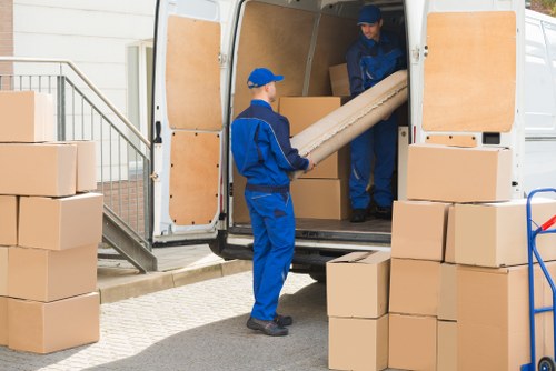 Professionals removing a sofa from a home in Welwyn