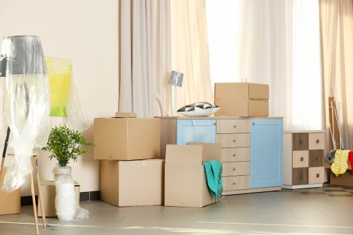 Professional sofa removal team handling furniture in a Watford home