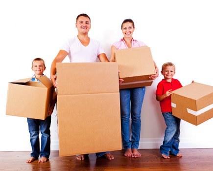 Professionals removing a large sofa from a living room
