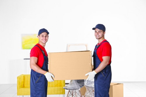 Professional sofa removal team handling a large sofa