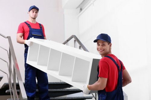 Professionals removing a sofa from a living room in High Wycombe